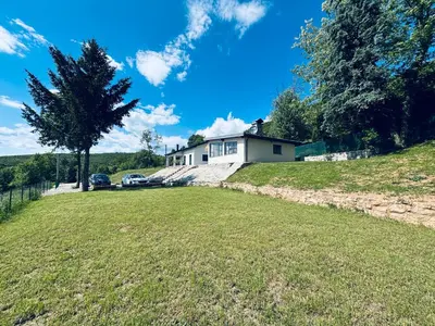 a house on the side of a hill with a yard at Holiday Home Silenzio in Bihać
