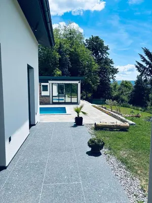 a house with a concrete walkway leading to a pool at Holiday Home Silenzio in Bihać