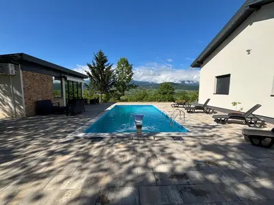a swimming pool in the middle of a patio at Holiday Home Silenzio in Bihać