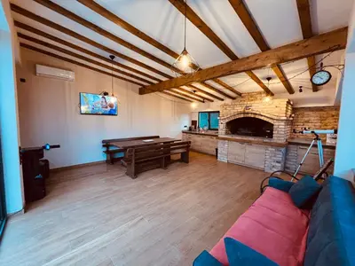 a living room with a couch and a ping pong table at Holiday Home Silenzio in Bihać