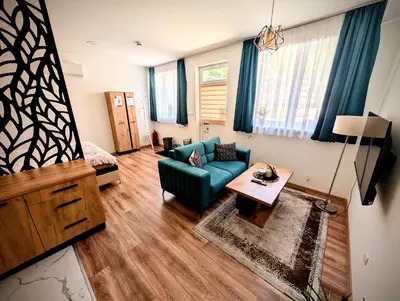 a living room with a couch and a table at Apartmani Dinarika in Livno