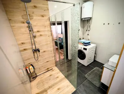 a shower with a glass door in a bathroom at Apartmani Dinarika in Livno