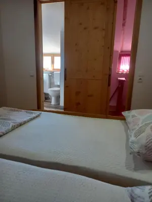 a bedroom with a bed and a bathroom with a mirror at Kuća za odmor Vidikovac in Rumboci