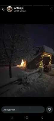 a picture of a house in the snow at night at Kuća za odmor Vidikovac in Rumboci