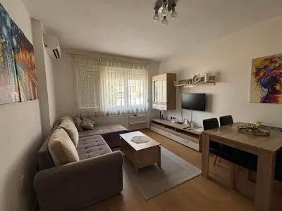 a living room with a couch and a table at Apartman Urbana Oaza in Banja Luka