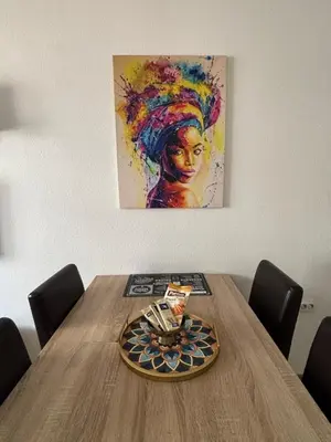 a table with a plate on it with a painting at Apartman Urbana Oaza in Banja Luka