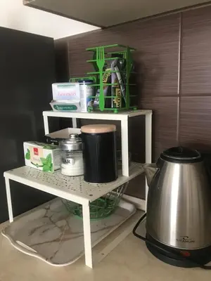 a white shelf with items on it in a kitchen at Apartman Urbana Oaza in Banja Luka