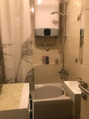 a bathroom with a bath tub and a sink at Apartman Urbana Oaza in Banja Luka