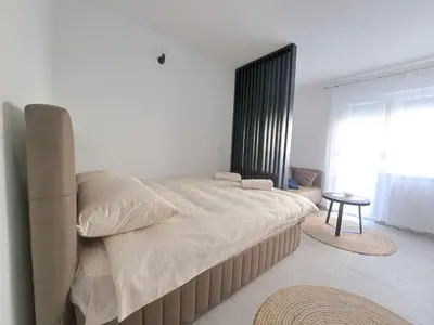 a bedroom with a large bed and a window at Apartman Lamini in Livno