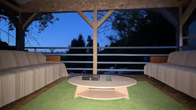 a room with two couches and a table on a patio at Vila N&M in Visoko