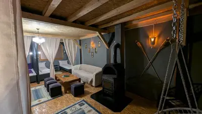 a room with a living room with a stove in it at Vila N&M in Visoko