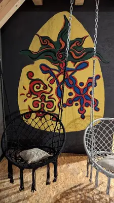 a swing in a room with a painting on the wall at Vila N&M in Visoko
