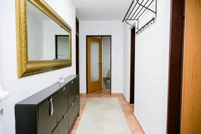 a bathroom with a vanity and a mirror on the wall at Apartman ATLAS in Jajce