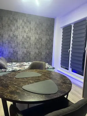 a dining room with a table and two chairs at Apartman CITY CENTER 5 in Prijedor