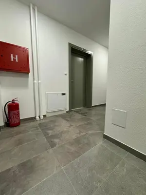 an empty room with a door and a fire hydrant at Apartman CITY CENTER 5 in Prijedor
