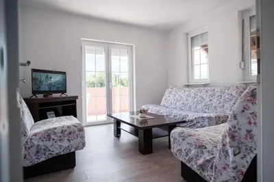 a living room with two couches and a coffee table at Kuća za odmor -Megy- in Kupres