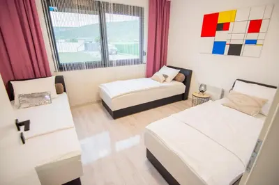 a small room with two beds and a window at Villa Lea in Bihać