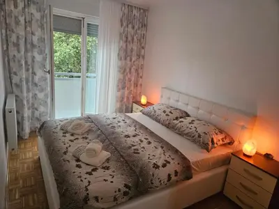 a bedroom with a bed with two towels on it at Apartman Atina Doboj in Doboj