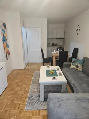 a living room with a couch and a table at Apartman Atina Doboj in Doboj