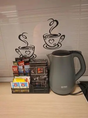 a coffee mug sitting on top of a table with books at Apartman Atina Doboj in Doboj