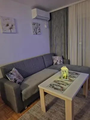 a living room with a couch and a coffee table at Apartman Atina Doboj in Doboj