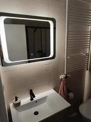 a bathroom with a white sink and a mirror at Apartman Mia Kupres in Kupres