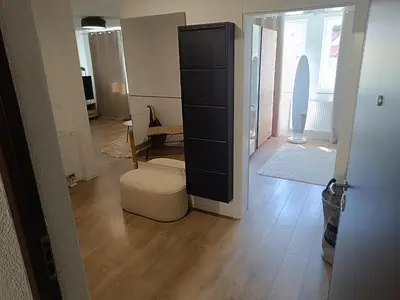 a living room with a black dresser and a room at Apartman Mia Kupres in Kupres