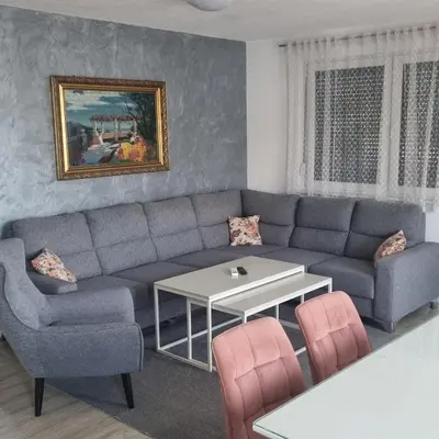 a living room with a couch and a table at Exclusive Kiseljak apartman in Kiseljak