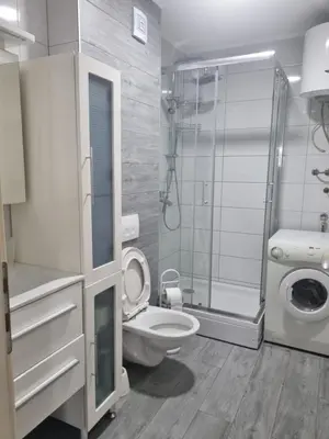 a bathroom with a toilet and a glass shower at Exclusive Kiseljak apartman in Kiseljak