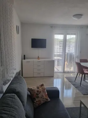 a living room with a couch and a tv at Exclusive Kiseljak apartman in Kiseljak