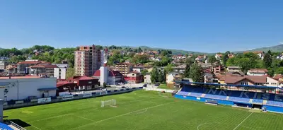 a soccer field in front of a city at Exclusive Kiseljak apartman in Kiseljak