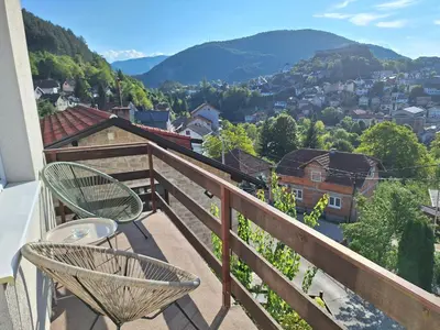 a balcony with chairs and a view of a city at Apartman Look in Jajce