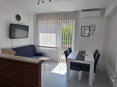a living room with a blue couch and a table at Apartman Look in Jajce
