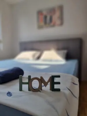 a sign that says hope sitting on a bed at Garden House in Tuzla