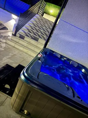 a blue bath tub sitting next to a building at Residence La Femme in Tuzla