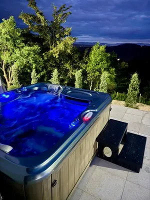a blue hot tub sitting on a patio at Residence La Femme in Tuzla