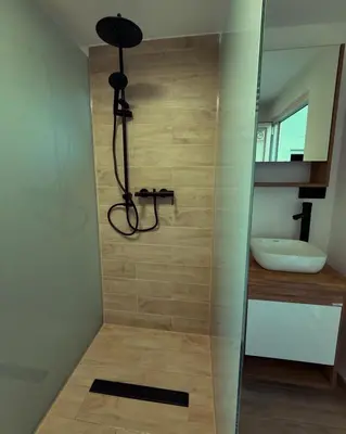 a shower in a bathroom with a sink at Residence La Femme in Tuzla