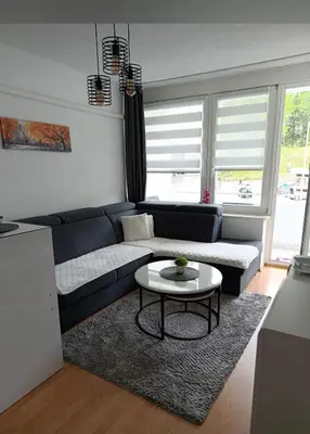 a living room with a couch and a table at Apartman City in Jajce