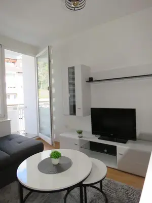 a living room with a couch and a tv at Apartman City in Jajce