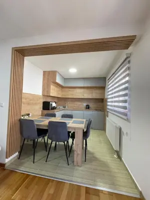 a kitchen and dining room with a table and chairs at Montis Vlasic Apartment 2 in Vlasic