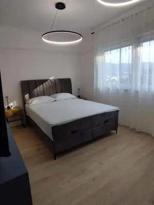 a bedroom with a large bed and a large window at Apartman Skyroom in Banja Luka