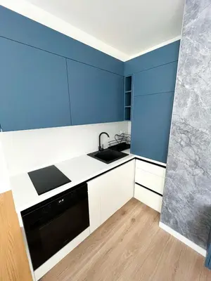 a blue and white kitchen with a sink and a dishwasher at Apartman Skyroom in Banja Luka