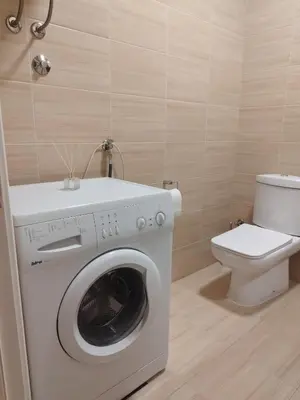 a bathroom with a washing machine and a toilet at Apartman Skyroom in Banja Luka