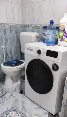 a washing machine in a bathroom with a toilet at Apartman Iris in Tuzla