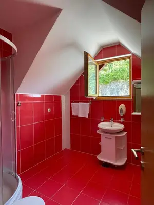 a red bathroom with a sink and a window at Restoran Motel Kanjon in Skender Vakuf