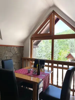a dining room with a table and a large window at Restoran Motel Kanjon in Skender Vakuf