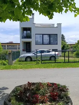 a car parked in front of a house at Apartman Una na dlanu, Novi Grad in Bosanski Novi