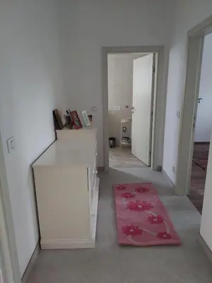 a white room with a red rug on the floor at Apartman Una na dlanu, Novi Grad in Bosanski Novi