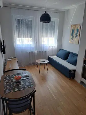 a living room with a couch and a table at Real Dream in Prijedor