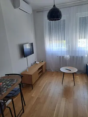 a living room with a table and a tv at Real Dream in Prijedor